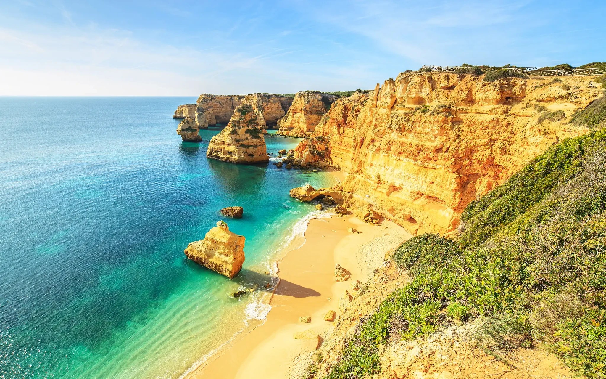 Golden limestone cliffs and turquoise water on Portugal's Algarve coast
