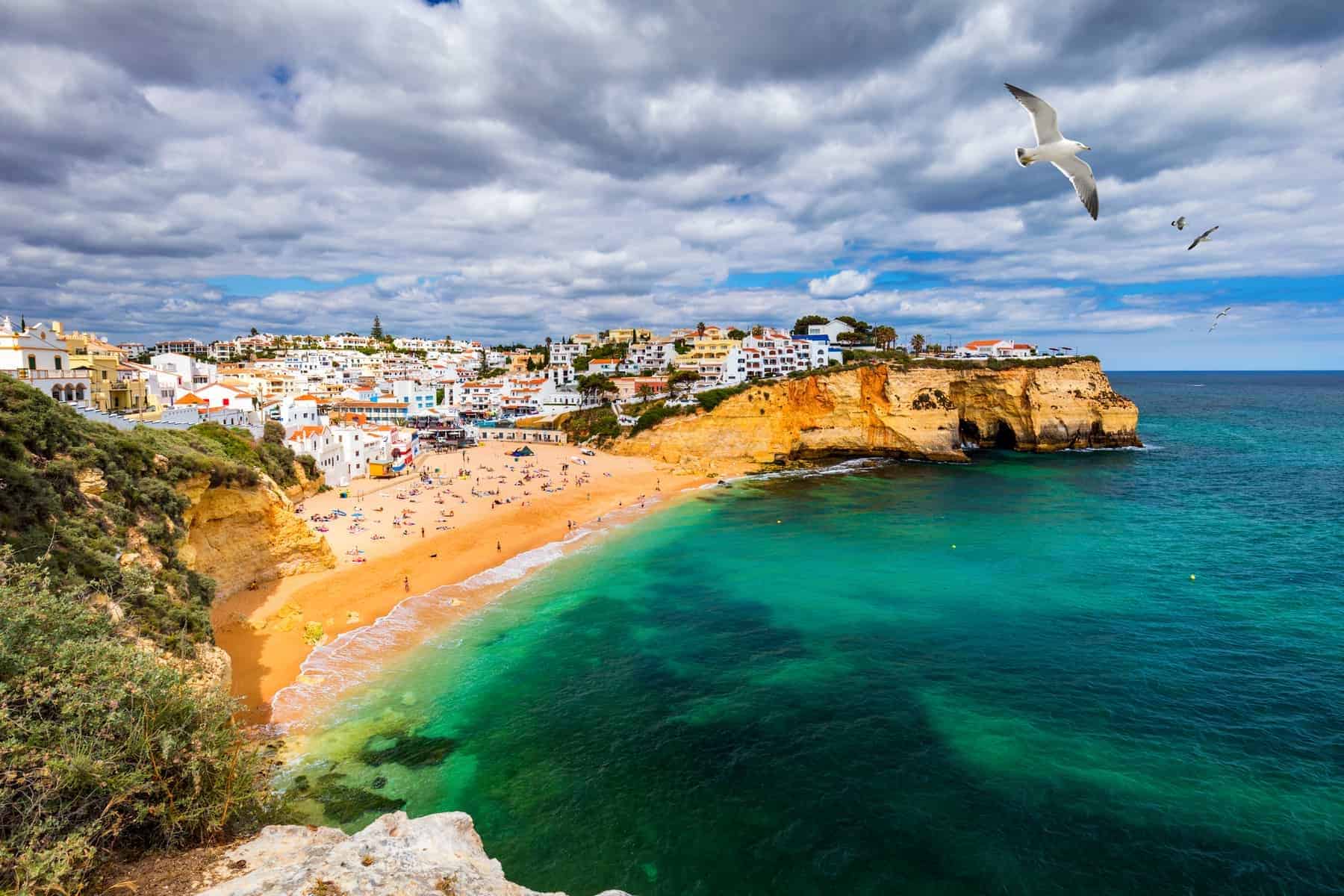 The whitewashed village of Carvoeiro above a sandy cove in the Algarve, Portugal